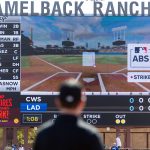 An umpire looks at the Jumbotron during an automated ball-strike challenge during spring training game between the Dodgers and White Sox at Camelback Ranch in March.